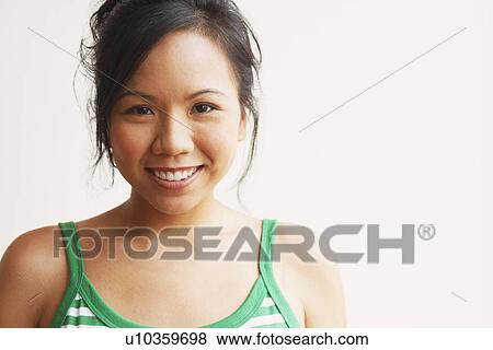 Portrait of a young woman smiling View Large Photo Image Stock Photo - Portrait of a young woman smiling. Fotosearch