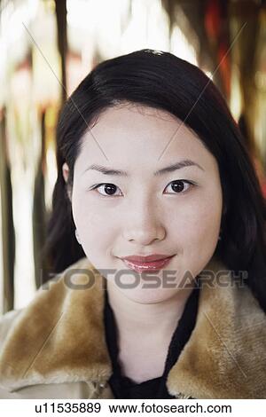 Stock Photo - Portrait of a young woman smiling. Fotosearch