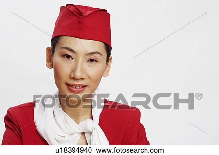 Stock Image - Portrait of an air stewardess smiling. Fotosearch
