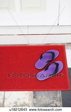 High Angle View Of A Pair Of Flip Flop On A Doormat Stock Image