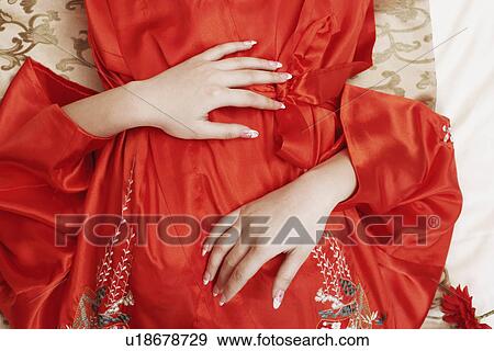 Mid section view of a woman lying on her back View Large Photo Image Stock Photo - Mid section view of a woman lying on her back. Fotosearch