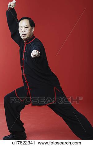 Stock Image - Portrait of a mature man pointing. Fotosearch