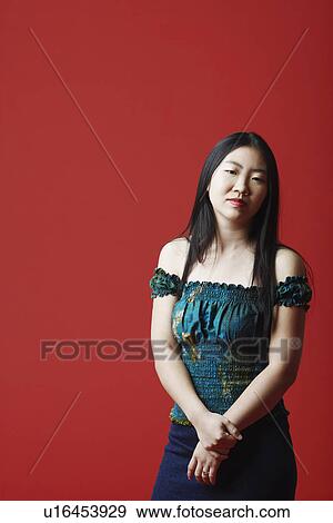 Portrait of a young woman standing View Large Photo Image Stock Photo - Portrait of a young woman standing. Fotosearch