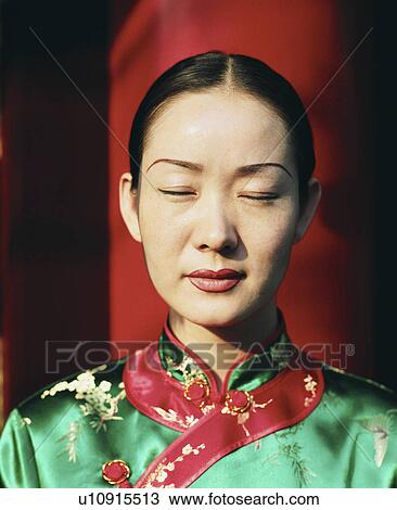 Stock Image - Close-up of a young woman meditating with her eyes closed. Fotosearch