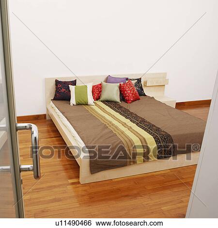 Stock Photograph - Double bed in a bedroom. Fotosearch
