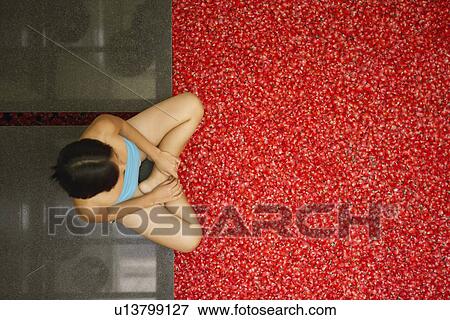 High angle view of a young woman sitting near a hot tub filled with rose petals View Large Photo Image Stock Photo - High angle view of a young woman sitting near a hot tub filled with rose petals. Fotosearch