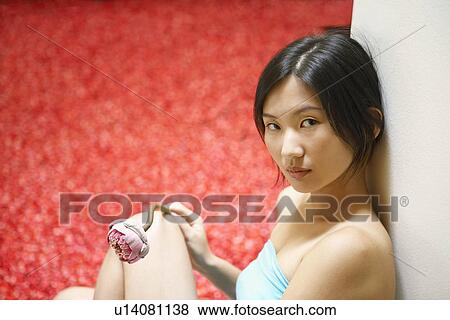 Portrait of a young woman leaning against a wall and thinking View Large Photo Image Stock Photo - Portrait of a young woman leaning against a wall and thinking. Fotosearch
