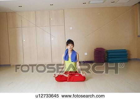 Stock Photography - Portrait of a young woman meditating. Fotosearch