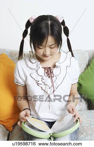 High angle view of a young woman holding a CD case View Large Photo Image Stock Photograph - High angle view of a young woman holding a CD case. Fotosearch