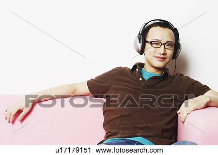 Portrait of a young man wearing headphones View Large Photo Image Stock Image - Portrait of a young man wearing headphones. Fotosearch