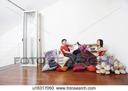 Side profile of a mid adult man with a young woman reclining on a couch and looking at each other View Large Photo Image Stock Image - Side profile of a mid adult man with a young woman reclining on a couch and looking at each other. Fotosearch
