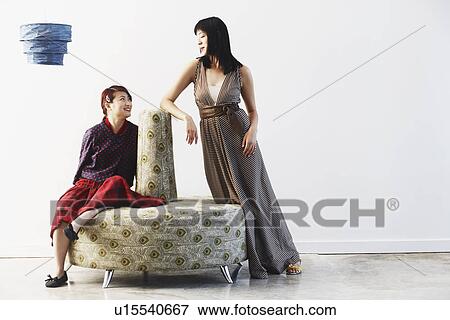Stock Photo - Two young women looking at each other. Fotosearch