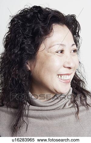 Close-up of a businesswoman looking sideways smiling View Large Photo Image Stock Photography - Close-up of a businesswoman looking sideways smiling. Fotosearch