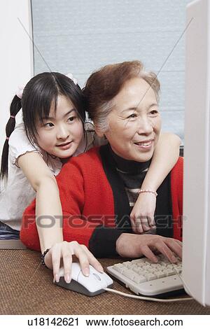 Close-up of a granddaughter standing beside her grandmother View Large Photo Image Stock Image - Close-up of a granddaughter standing beside her grandmother. Fotosearch