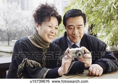 Stock Photograph - Close-up of a mature man looking at a digital camera. Fotosearch