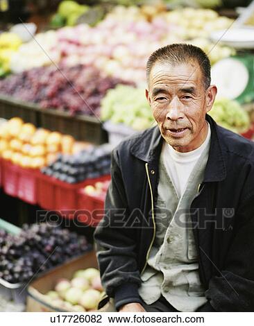 High angle view of a senior man sitting in front of a vegetable stand View Large Photo Image Stock Image - High angle view of a senior man sitting in front of a vegetable stand. Fotosearch