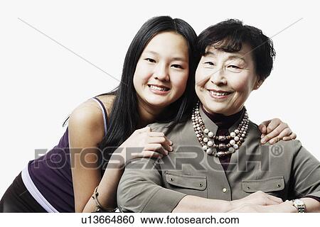 Stock Image - Portrait of a grandmother and her granddaughter smiling. Fotosearch