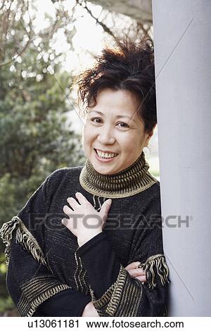 Portrait of a mature woman smiling View Large Photo Image Stock Image - Portrait of a mature woman smiling. Fotosearch