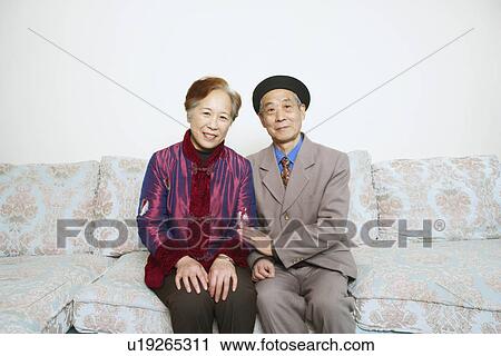 Portrait of a senior man sitting on a couch with a mature woman View Large Photo Image Stock Image - Portrait of a senior man sitting on a couch with a mature woman. Fotosearch