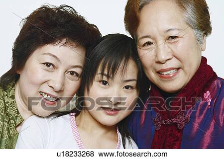 Stock Photo - Portrait of a young woman with two mature women smiling. Fotosearch