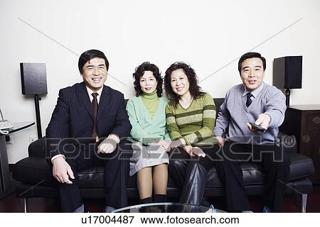 Portrait of two mature couples sitting together on a couch smiling View Large Photo Image Stock Photo - Portrait of two mature couples sitting together on a couch smiling. Fotosearch