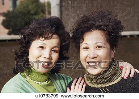 Stock Photo - Portrait of two mature women smiling. Fotosearch