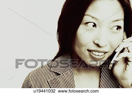 Stock Image - Close-up of a businesswoman talking on a mobile phone. Fotosearch