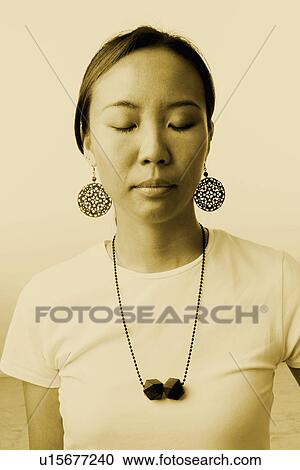 Close-up of a young woman with her eyes closed View Large Photo Image Stock Image - Close-up of a young woman with her eyes closed. Fotosearch