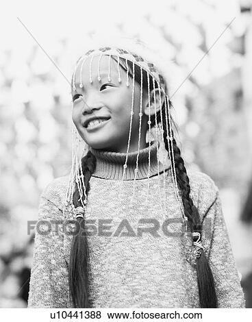Stock Photo - Low angle view of a girl wearing ornate headdress. Fotosearch