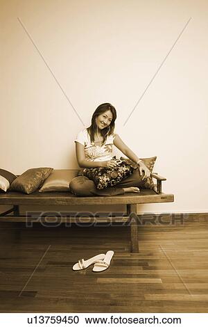 Portrait of a young woman listening to an MP3 player View Large Photo Image Stock Image - Portrait of a young woman listening to an MP3 player. Fotosearch