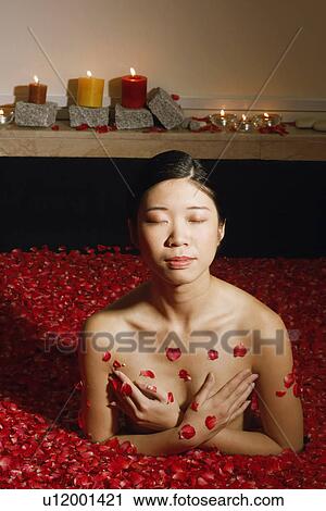 High angle view of a young woman in a bath tub full of rose petals with her eyes closed View Large Photo Image Stock Image - High angle view of a young woman in a bath tub full of rose petals with her eyes closed. Fotosearch
