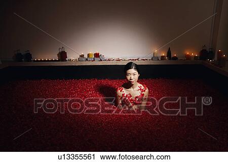 High angle view of a young woman in a bath tub full of rose petals View Large Photo Image Stock Image - High angle view of a young woman in a bath tub full of rose petals. Fotosearch