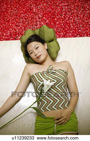 High angle view of a young woman lying on the floor near a hot tub filled with rose petals View Large Photo Image Stock Image - High angle view of a young woman lying on the floor near a hot tub filled with rose petals. Fotosearch