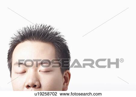 Stock Image - Close-up of a businessman with his eyes closed. Fotosearch