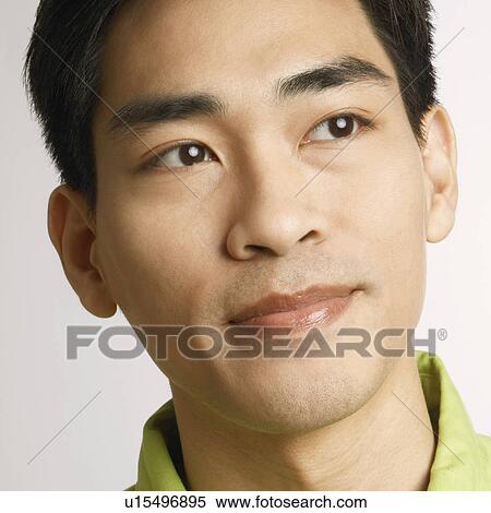 Stock Photography - Close-up of a mid adult man thinking. Fotosearch