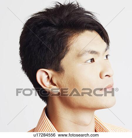 Close-up of a young man thinking View Large Photo Image Stock Photograph - Close-up of a young man thinking. Fotosearch