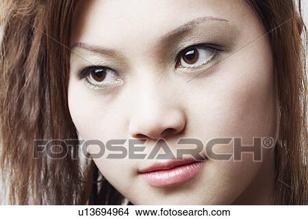 Picture - Close-up of a young woman thinking. Fotosearch