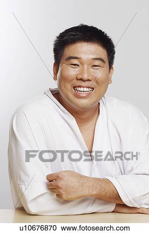 Portrait of a mid adult man wearing a karate uniform and smiling View Large Photo Image Stock Image - Portrait of a mid adult man wearing a karate uniform and smiling. Fotosearch