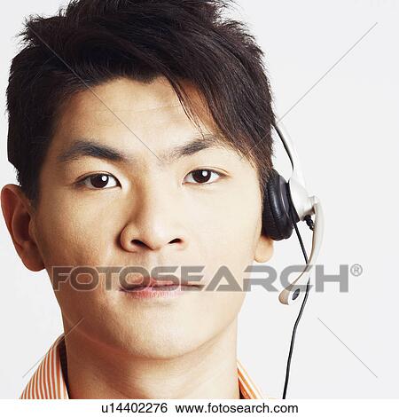 Portrait of a young man wearing a headset View Large Photo Image Stock Photograph - Portrait of a young man wearing a headset. Fotosearch