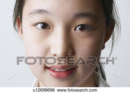 Portrait of a young woman smiling View Large Photo Image Stock Photo - Portrait of a young woman smiling. Fotosearch