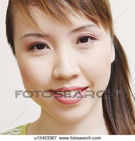 Stock Photo - Portrait of a young woman smiling. Fotosearch