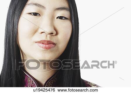 Stock Photograph - Portrait of a young woman thinking. Fotosearch