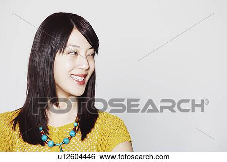 Stock Photograph - Close-up of a young woman smiling. Fotosearch