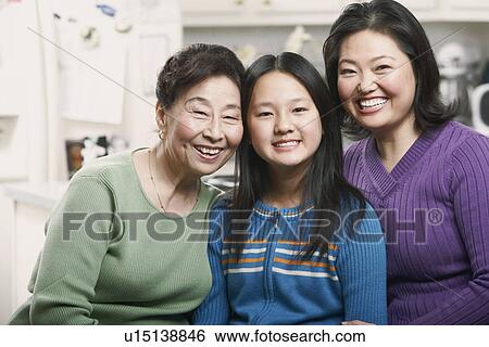 Portrait of a girl smiling with her mother and grandmother View Large Photo Image Stock Photograph - Portrait of a girl smiling with her mother and grandmother. Fotosearch