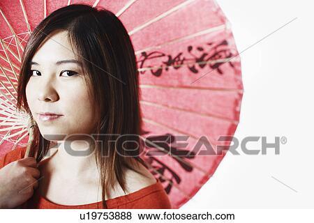 Portrait of a mid adult woman holding a parasol View Large Photo Image Stock Photo - Portrait of a mid adult woman holding a parasol. Fotosearch
