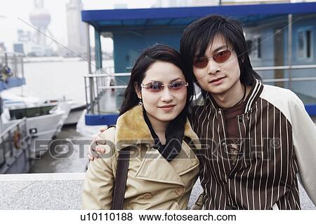 Portrait of a young couple smiling View Large Photo Image Stock Photo - Portrait of a young couple smiling. Fotosearch