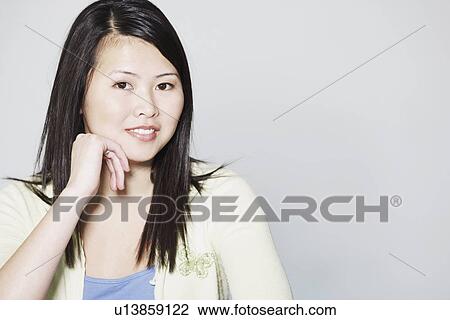Stock Image - Portrait of a young woman smiling. Fotosearch