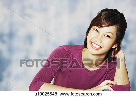 Stock Photo - Portrait of a young woman smiling. Fotosearch
