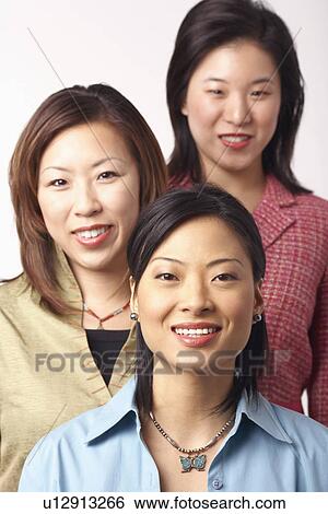 Portrait of three businesswomen smiling View Large Photo Image Stock Photograph - Portrait of three businesswomen smiling. Fotosearch