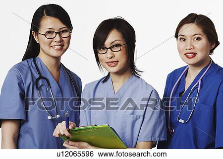Portrait of three female doctors standing together View Large Photo Image Stock Photograph - Portrait of three female doctors standing together. Fotosearch